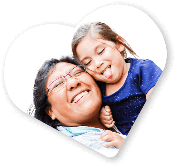 Decorative image of a smiling woman holding a young girl who is playfully sticking out her tongue.